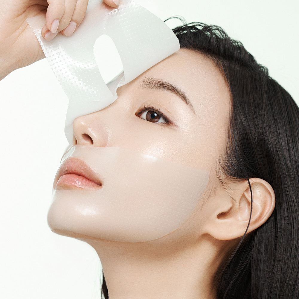 Arocell Cica Repair Panthenol Gel Mask being lifted off the face to show the thin gel sheet