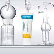 Dr.Melaxin TX Retinalsome Double Effect Eye Cream tube standing among laboratory glassware