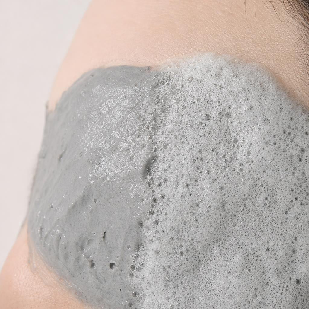 Elizavecca Milky Piggy Carbonated Bubble Clay Mask grey clay foaming into fine bubbles on a cheek