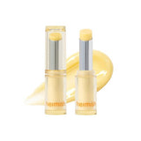 Heimish Ever Glow Glaze Nourishing Balm, two yellow-tinted clear balm sticks with a swatch on white