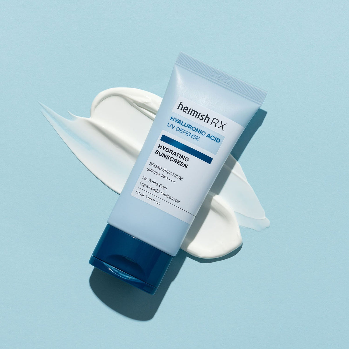 Heimish RX Hyaluronic Acid Hydrating Sunscreen tube lying on a swirl of white cream on a pale blue background