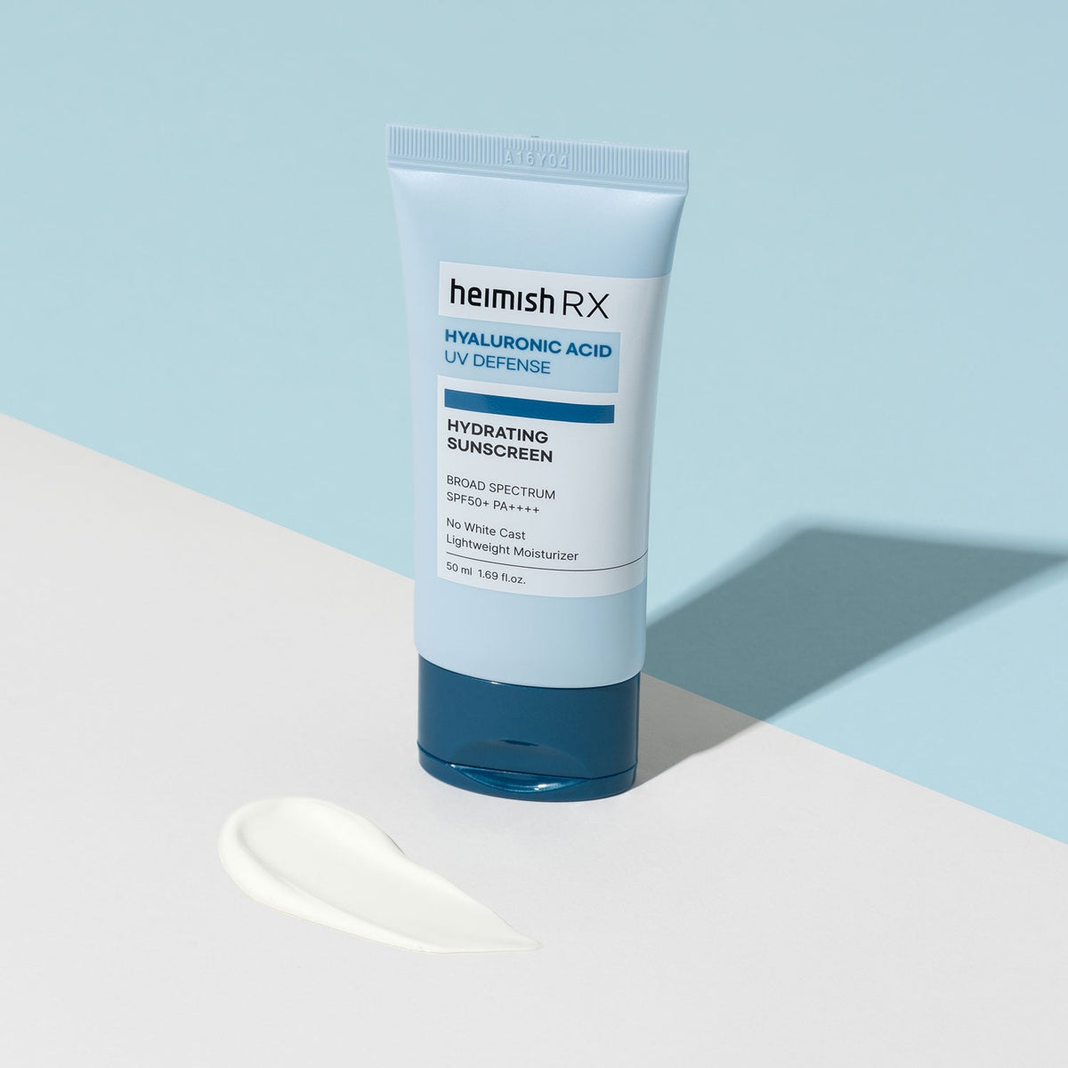 Heimish RX Hyaluronic Acid Hydrating Sunscreen tube on a white step beside a small cream swatch
