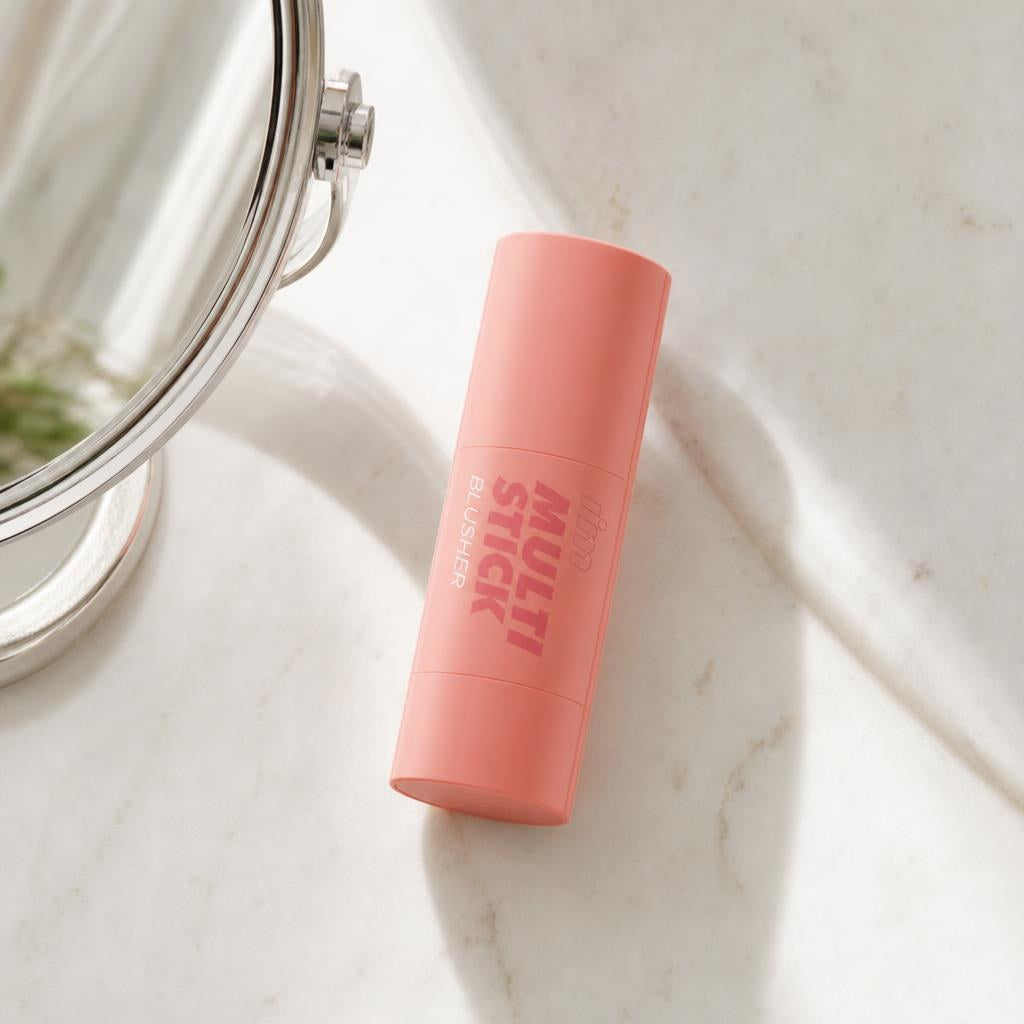I'm Meme I'm Multi Stick Blusher coral stick lying on a marble vanity beside a mirror