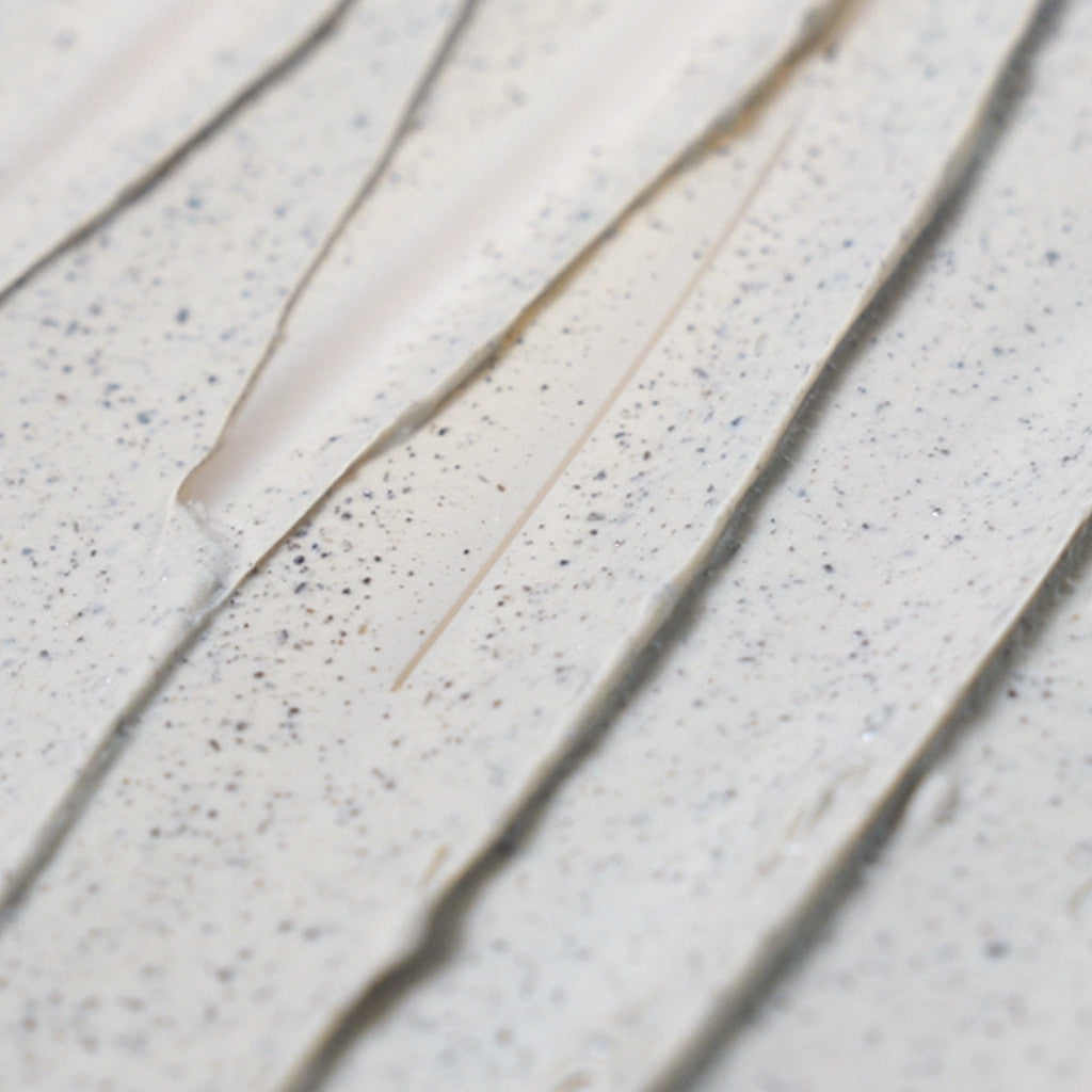 Isntree Mugwort Calming Clay Mask close-up of the creamy clay texture with mugwort leaf specks