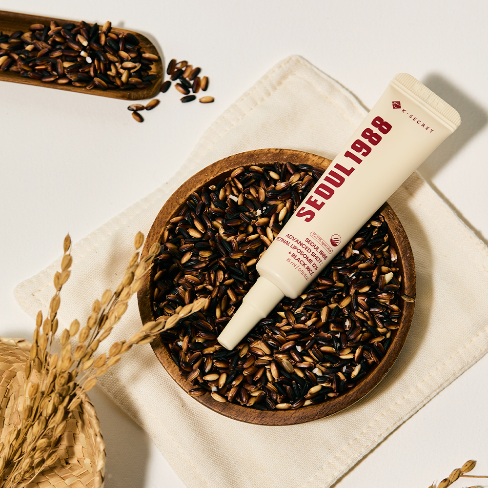 K-Secret Seoul 1988 Advanced Shot Retinal Liposome 12% + Black Rice tube resting on a bowl of black rice