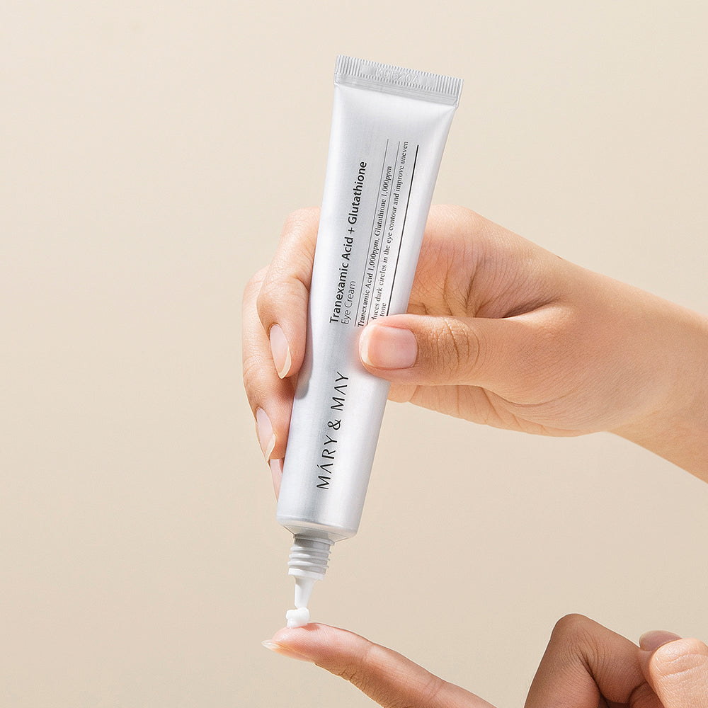 Mary&May Tranexamic Acid + Glutathione Eye Cream squeezed from the tube onto a fingertip