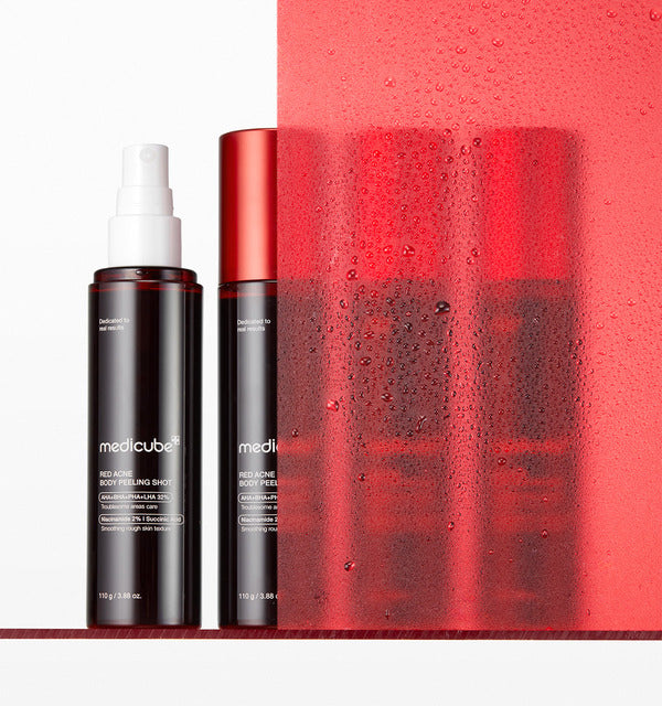 Medicube Red Acne Body Peeling Shot two bottles, one with the spray nozzle uncapped