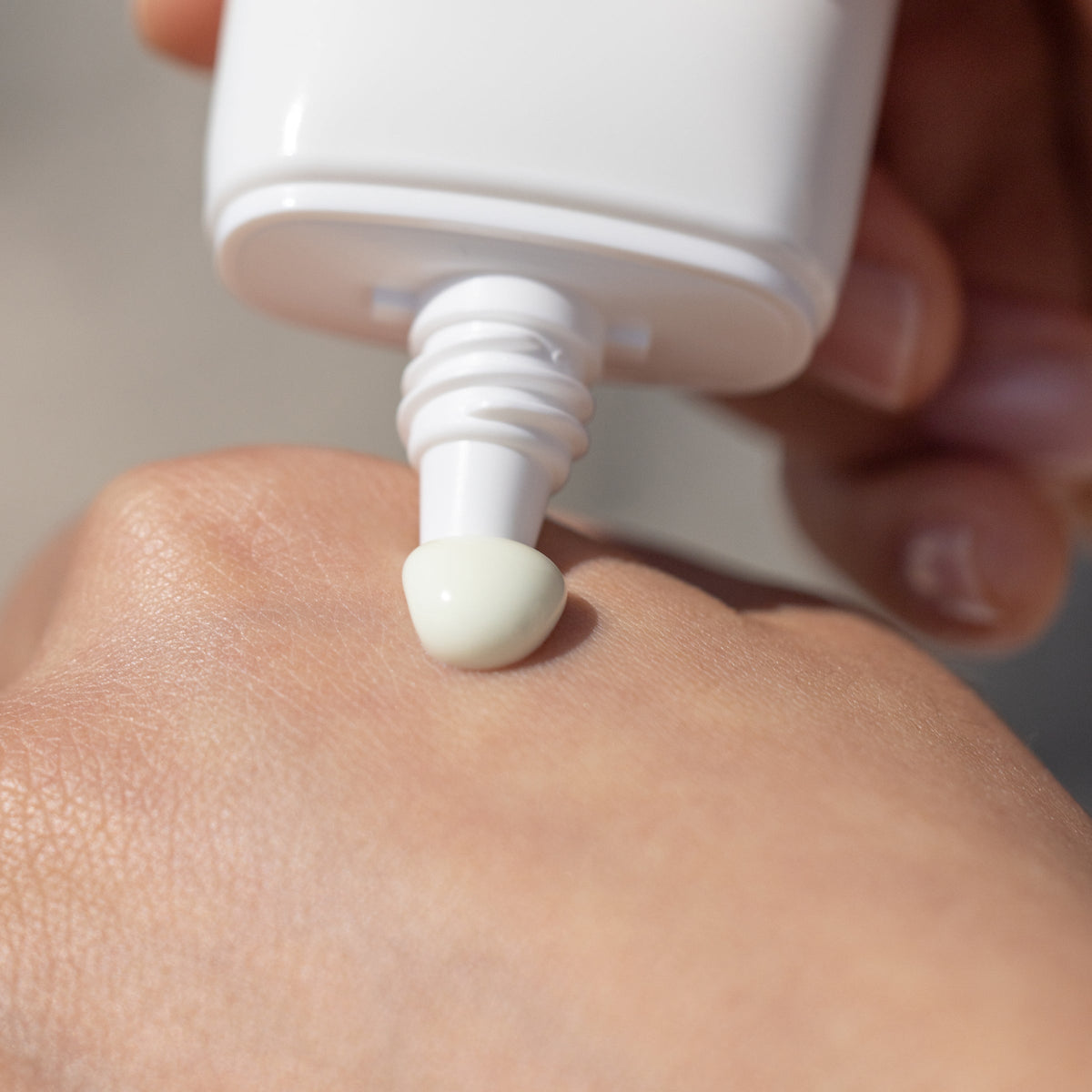Melixir Airfit Invisible Sunscreen SPF 50 squeezed from the tube onto the back of a hand