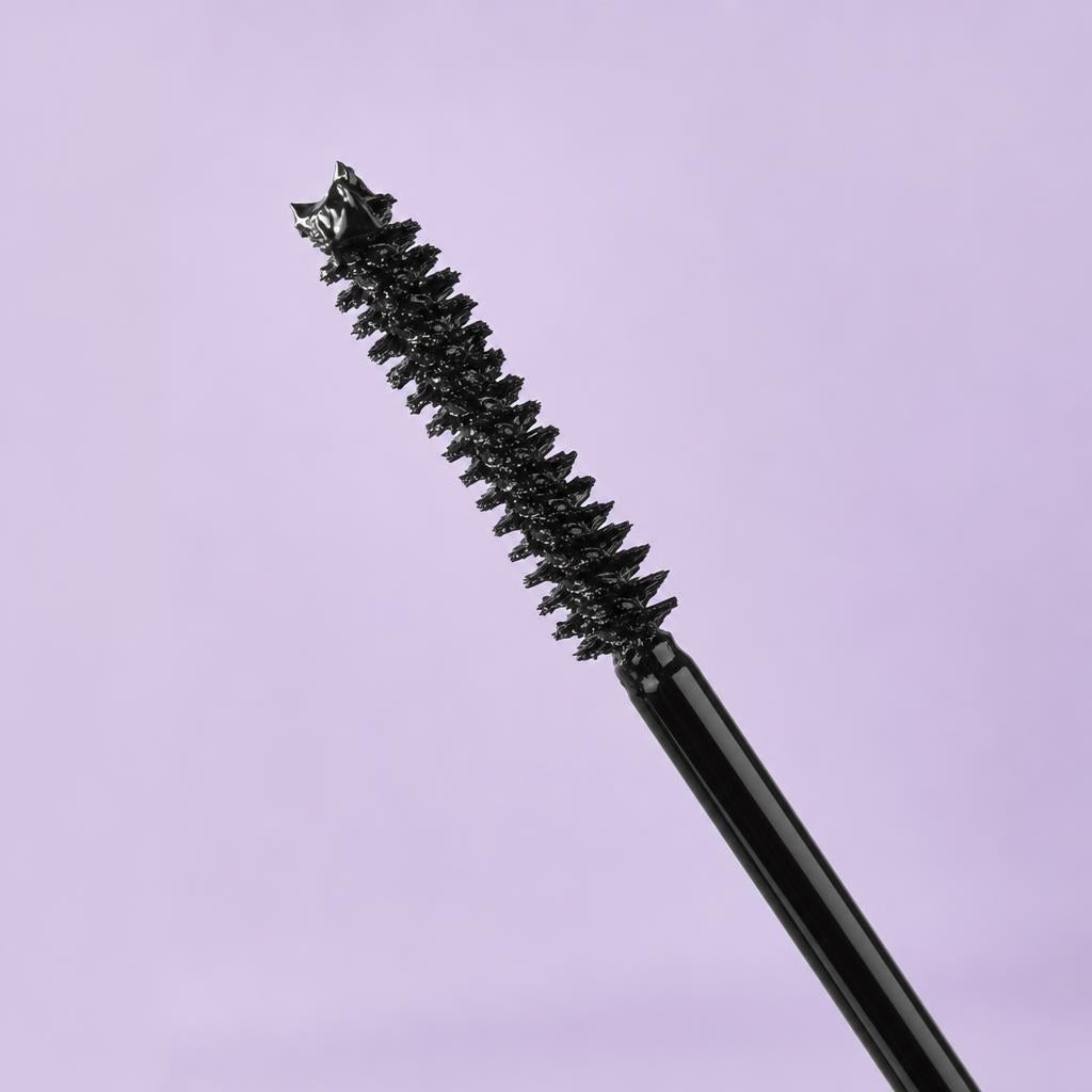 Mizon Collagen Curling Fix Mascara spiral brush coated in black formula on a lilac background