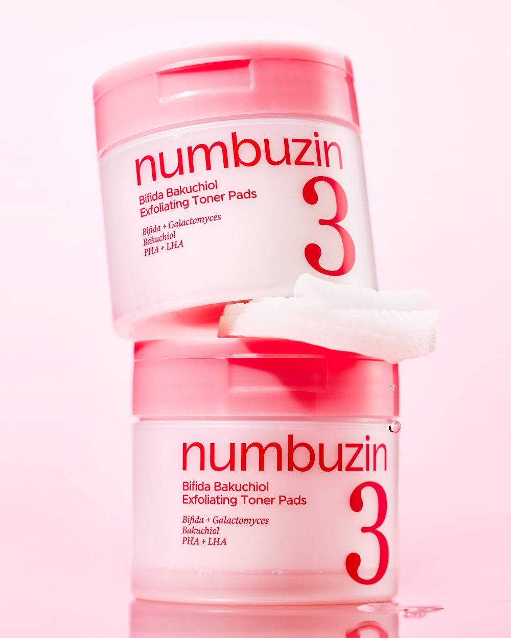 Numbuzin No.3 Bifida Bakuchiol Exfoliating Toner Pads two jars stacked with a soaked pad on a pink background