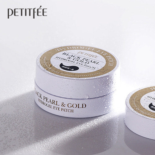 Petitfee Black Pearl & Gold Hydrogel Eye Patch stacked jars covered in water droplets