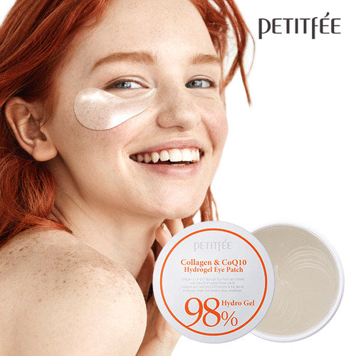 Petitfee Collagen & CoQ10 Hydrogel Eye Patch worn under the eye by a smiling model beside the open jar