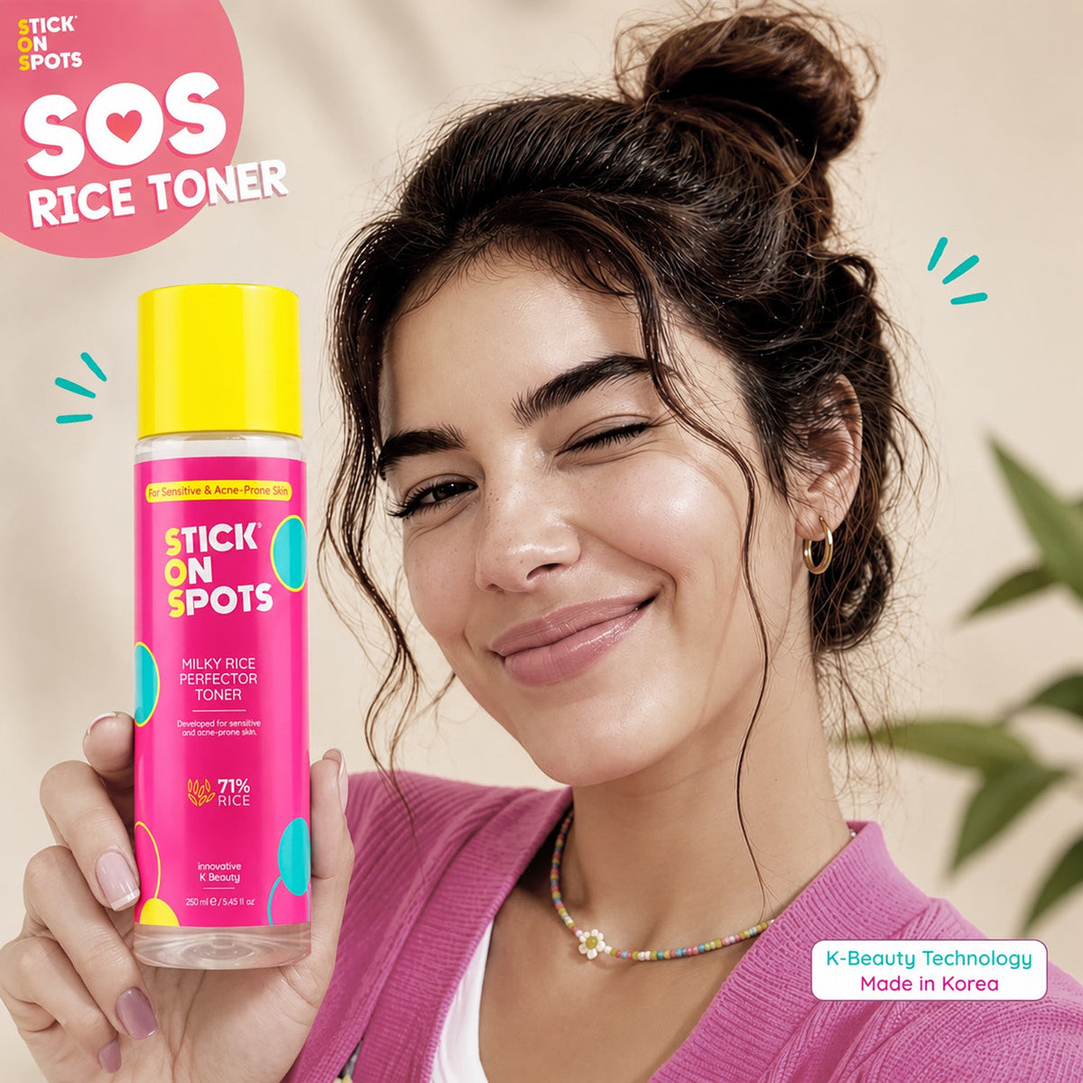 Woman holding the pink S.O.S Milky Rice Perfector Toner bottle near her face