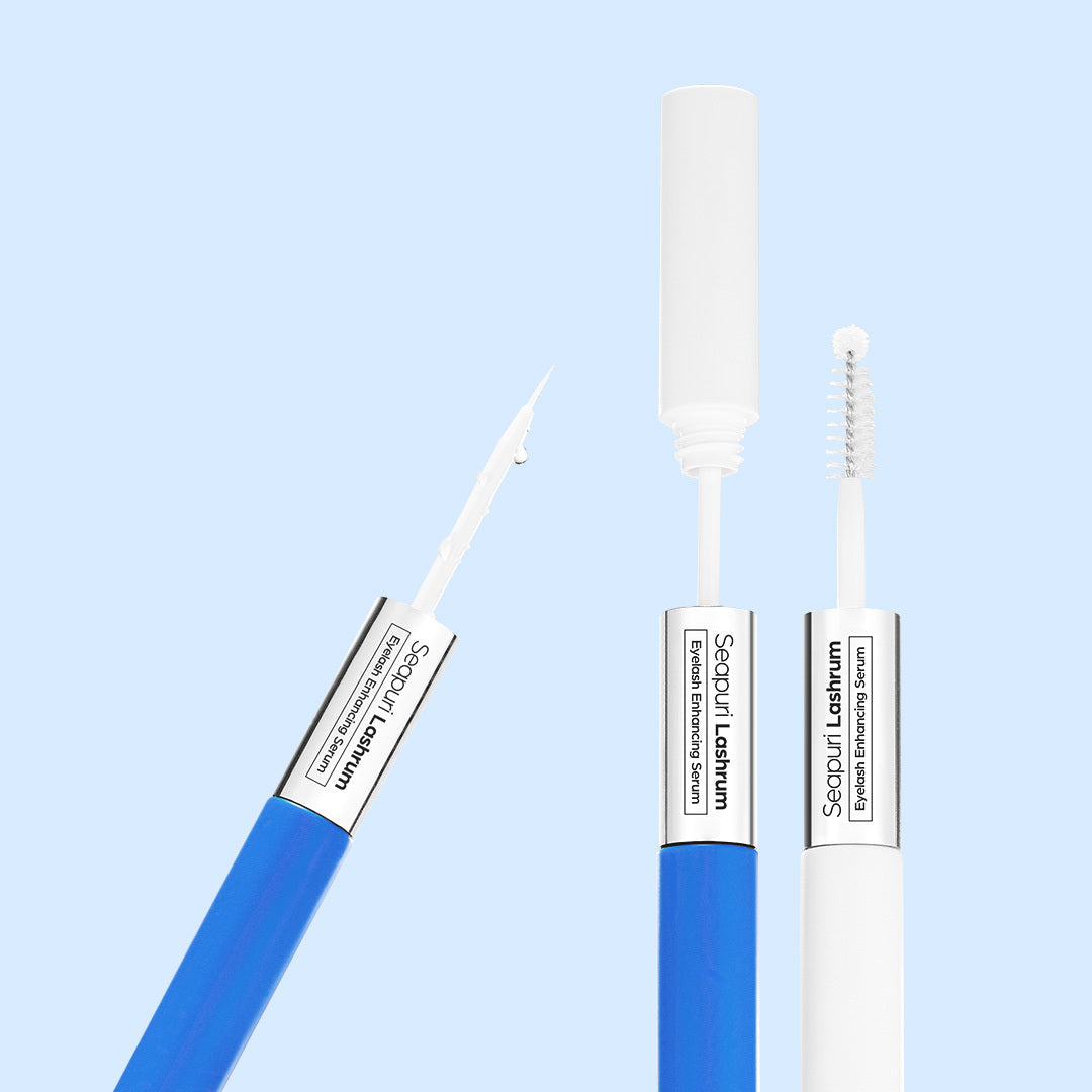 Seapuri Lashrum Eyelash Enhancing Serum shown open with its fine tip and brush applicators on a light blue background