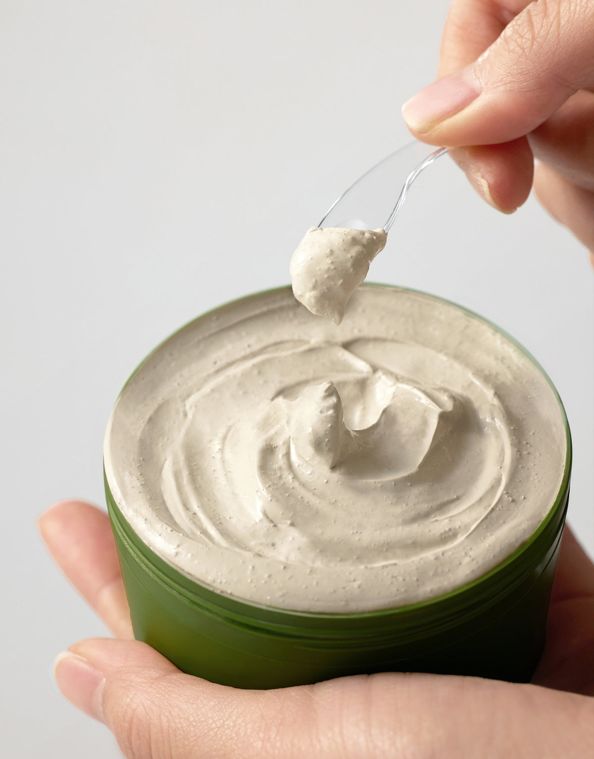 Some By Mi Super Matcha Pore Clean Clay Mask scooped from the jar with a clear spatula