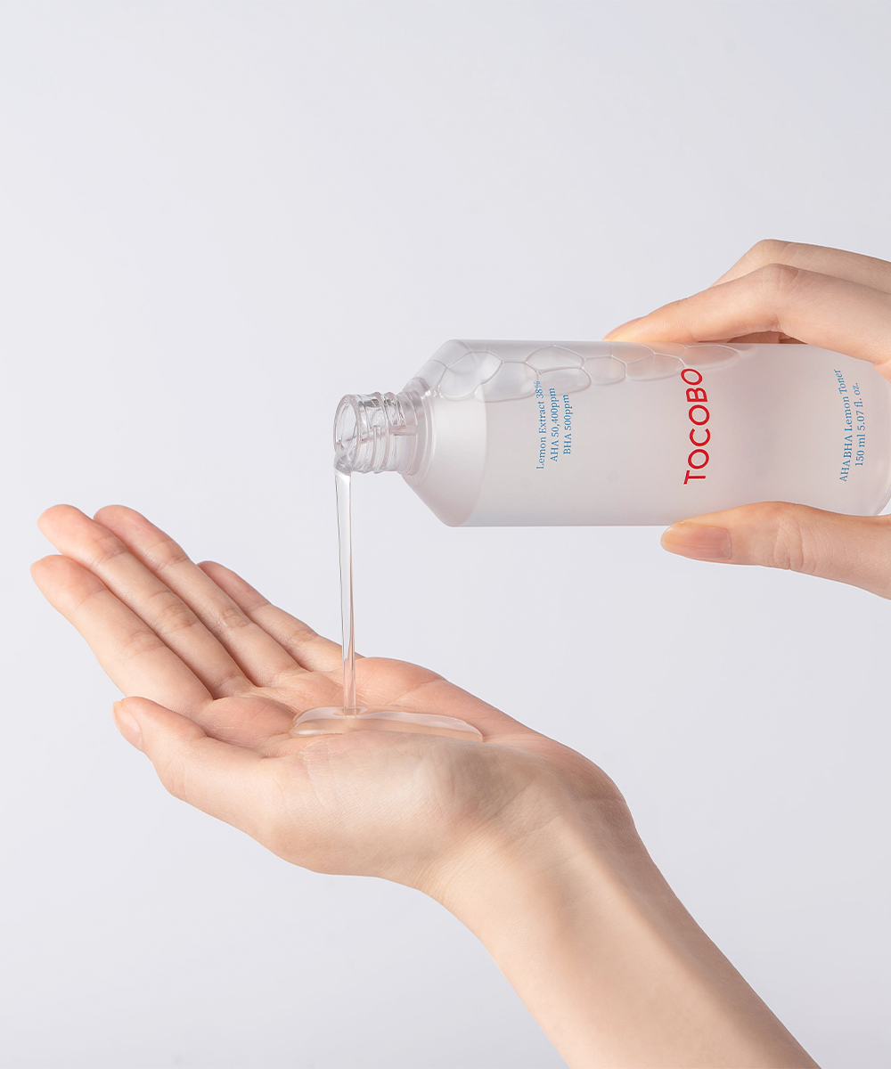 Tocobo AHA BHA Lemon Toner being poured from the bottle into an open palm