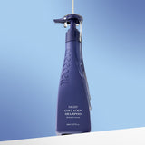 Treecell Night Collagen Shampoo Midnight Forest 360ml, navy pump bottle on a soft blue backdrop